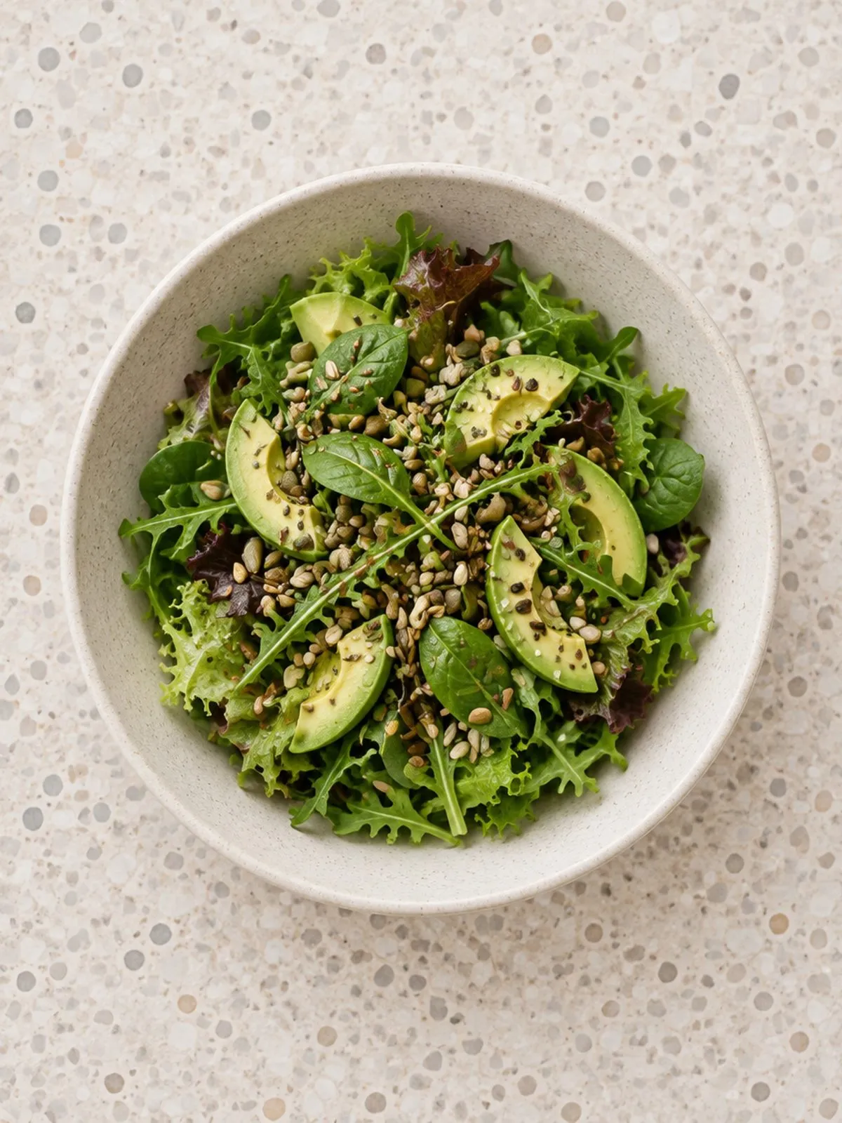 A green salad with avocado and seeds at Archi