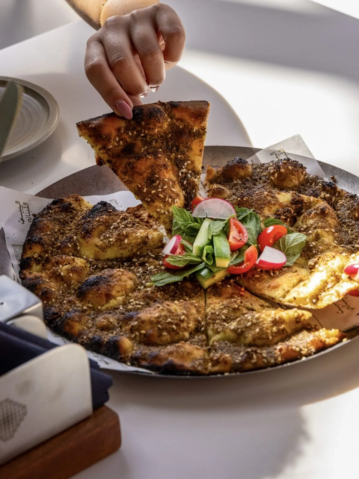 A flatbread being served at the table