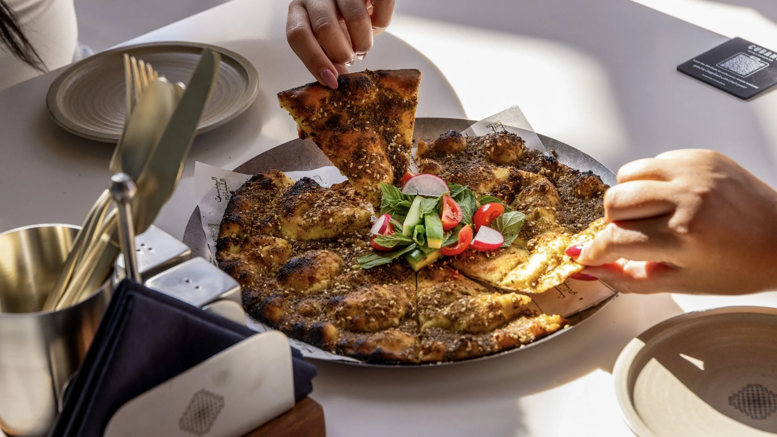 A flatbread being served at the table