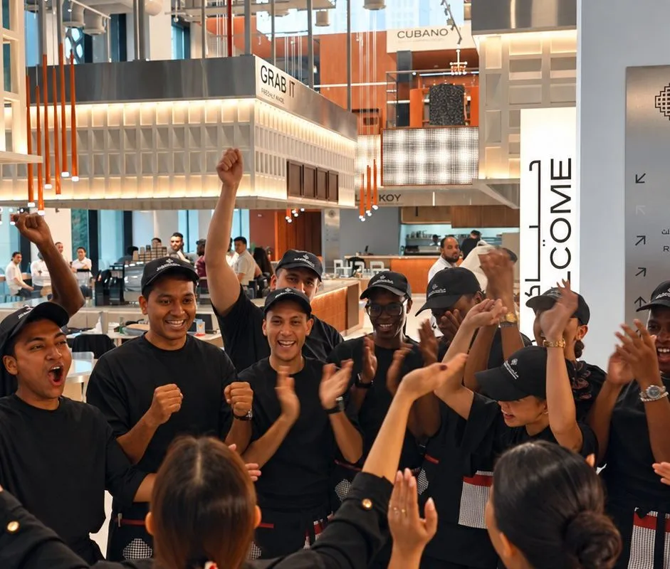 The Foodhall team in a huddle on the floor before service