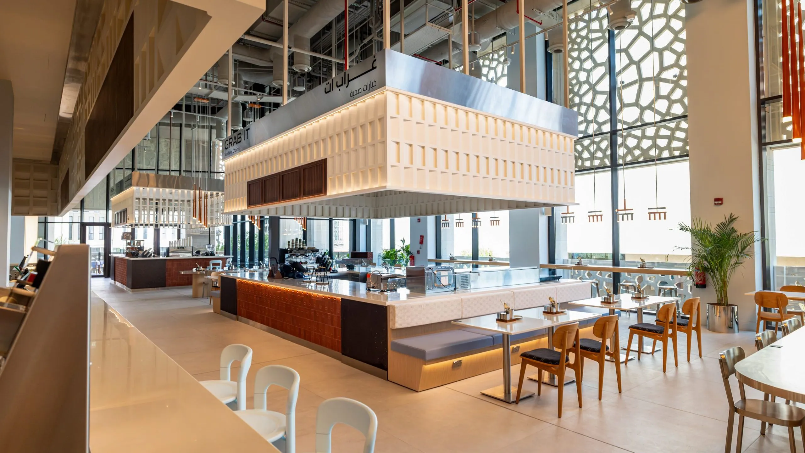 Daylight through the mashrabiya screens onto the tables